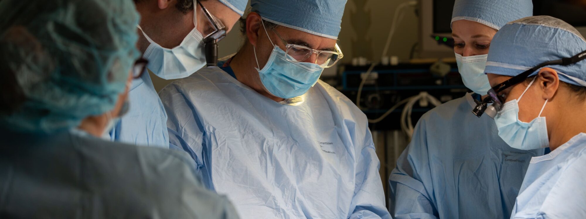 Dr. Justin Sacks and team in operating room performing a medical procedure.