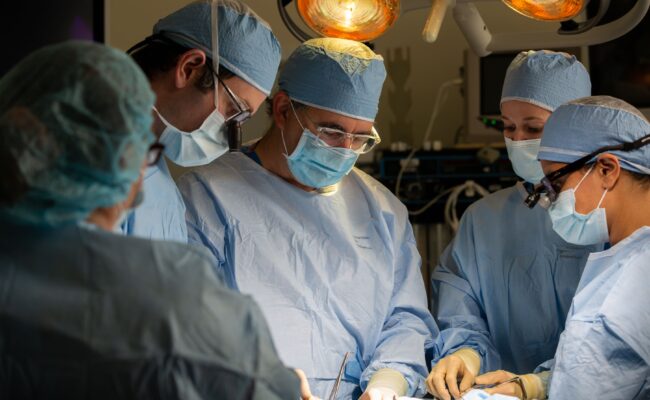 Dr. Justin Sacks and team in operating room performing a medical procedure.