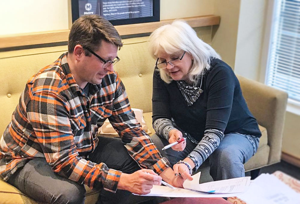 Garrett Van Dyke and Ann Campbell discussing a client's project.