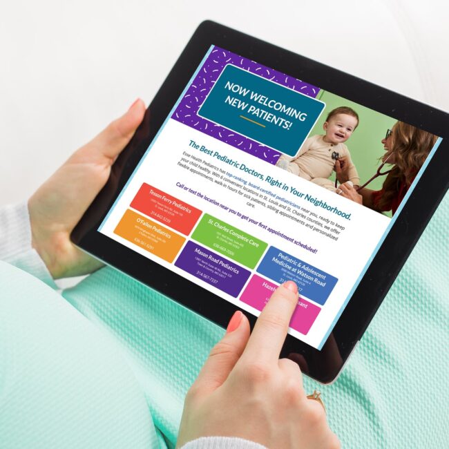 close up of pregnant person's hands holding an iPad displaying Esse Health Pediatrics webpage.