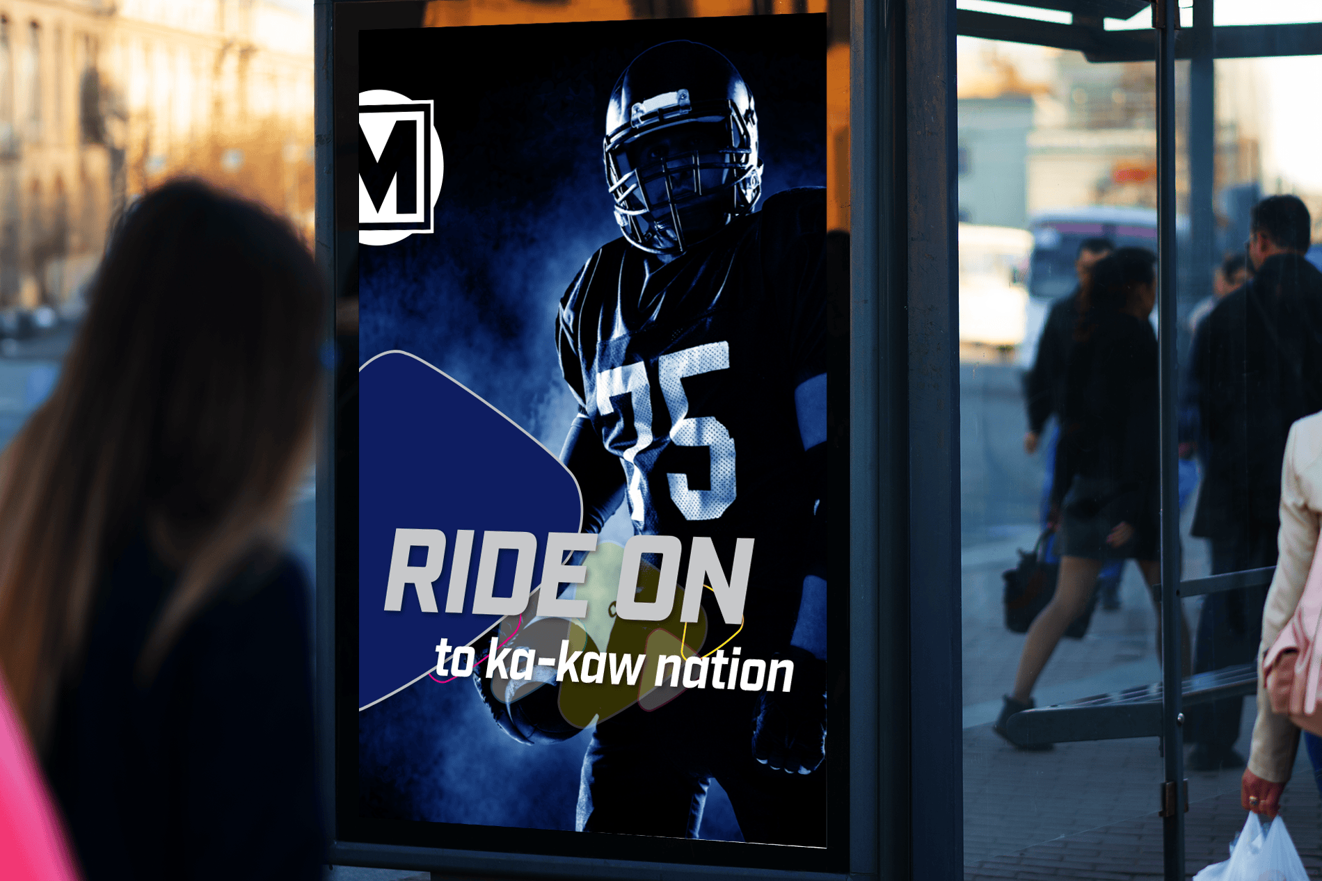 Image of a bus shelter displaying a RIDE ON poster featuring a player from the Battle Hawks football team - "RIDE ON to ka-kaw nation."